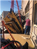 Skid Steer Being Lowered Through Sidewalk